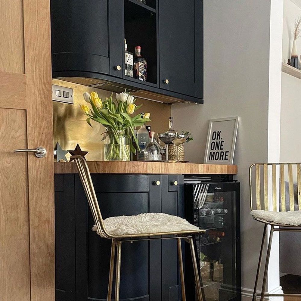 brass splash back in home bar area