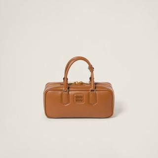 a brown miu miu top handle purse 