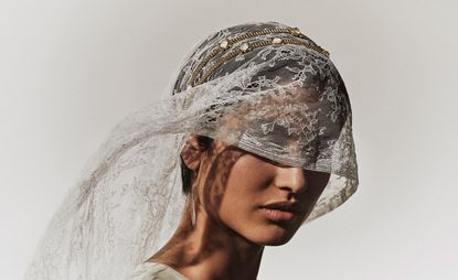 woman wears veil and Goossens bridal jewellery