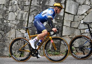 Remco Evenepoel riding his gold Specialized Tarmac SL8