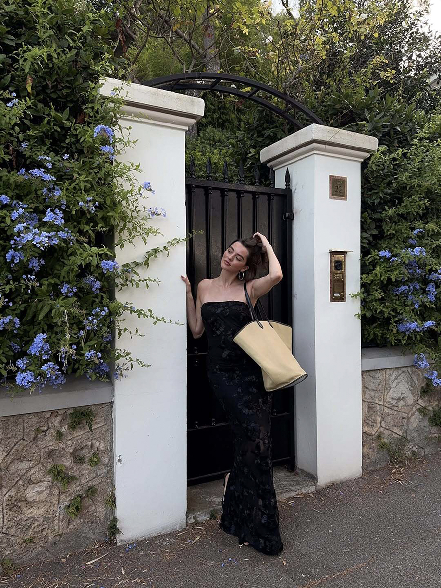 Mary L. Jean wears a black maxi dress and oversize bag while vacationing in the French Riviera.