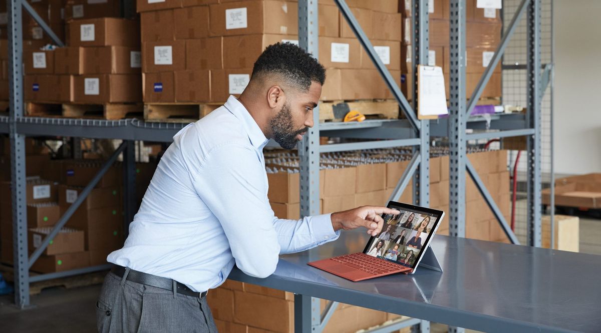 A businessman using the Microsoft Surface Pro 7 Plus to attend a video conference