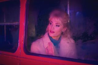 Barbara (Gemma Arteton) looks through a window in Funny Woman