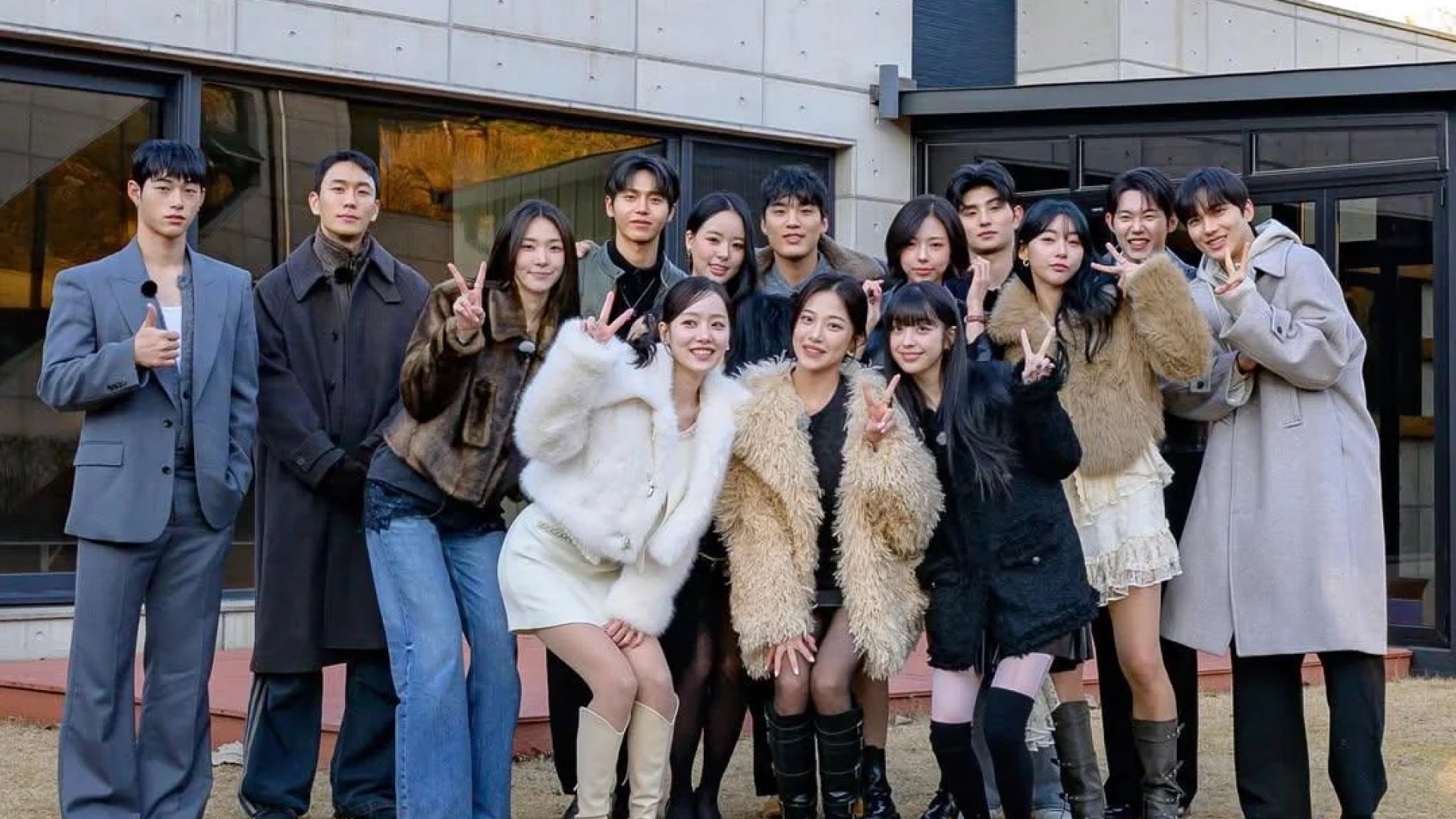 The 'Single's Inferno Reunion' cast poses for a group picture, standing outdoors on the front lawn of a modern home.