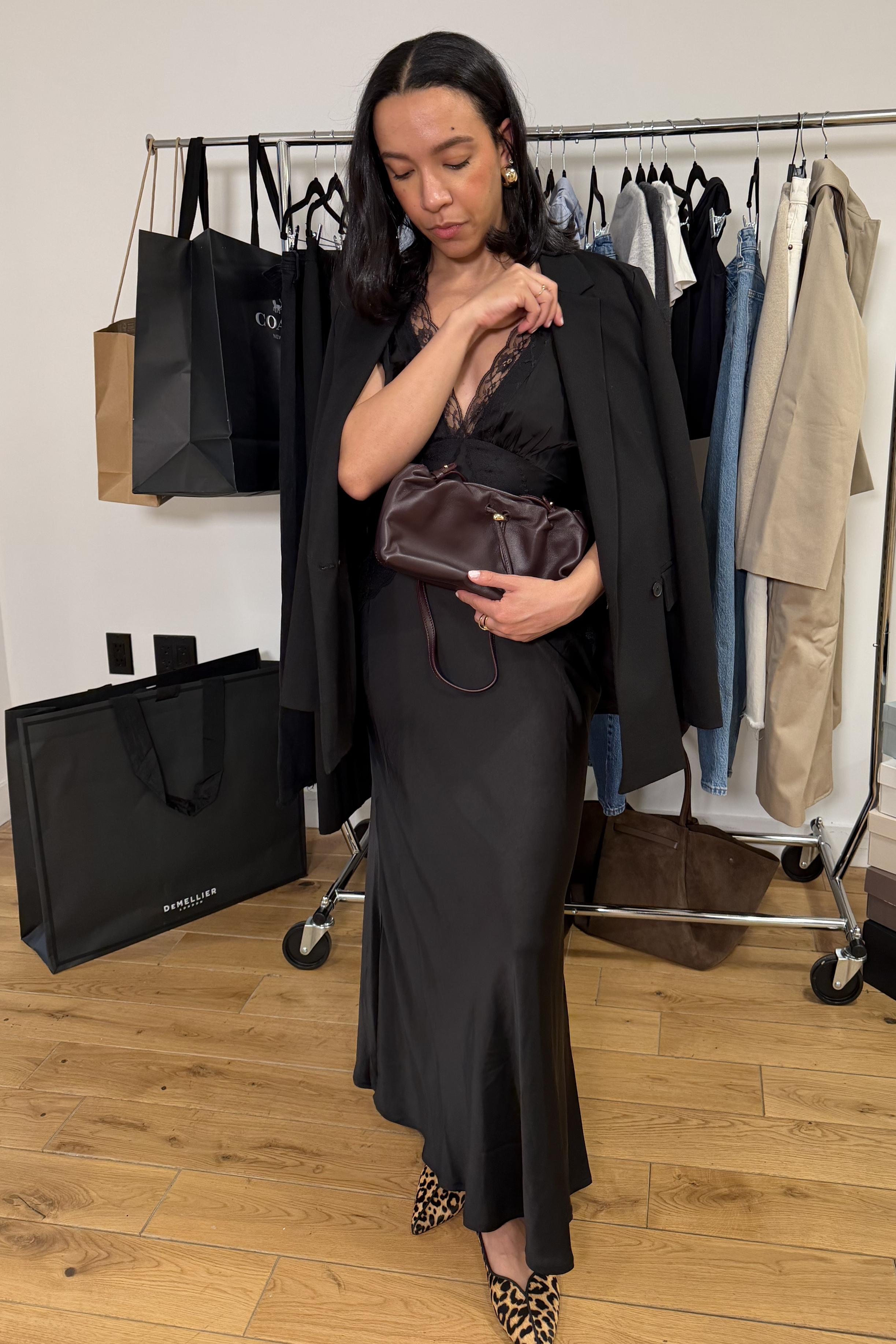 Lauren Tappan wearing a blazer, a satin dress, and high-vamp flats