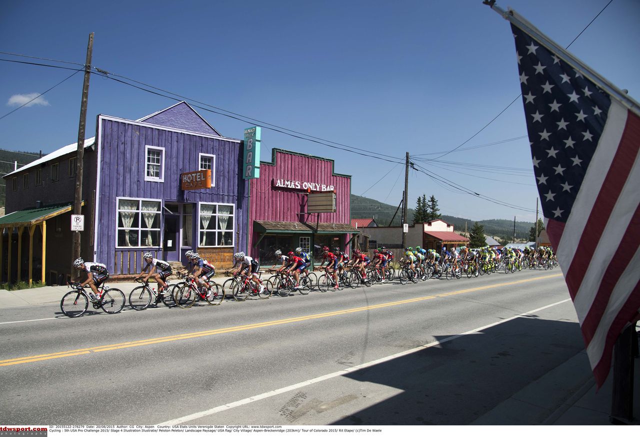 The riders pass some old buildings