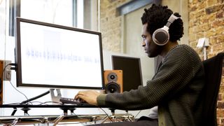 Man looks at waveform on a computer monitor