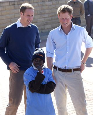 Prince Harry and Prince William take part in a game with HIV affected children at the Mamahato Network Club at King Letsie's Palace on June 17, 2010 in Maseru, Lesotho.