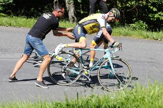 Wilco Kelderman gets a push from his team after rolling a tire on the descent during stage 8 at the Tour de France.