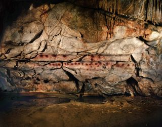 Red disk art at El Castillo cave in Spain