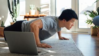 man doing a press up in his living room