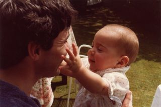Kate Middleton as a baby and her dad Michael holding her in the garden