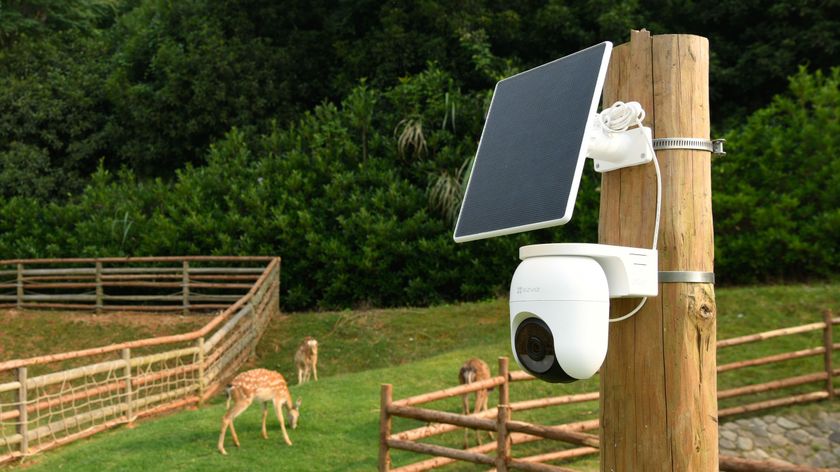 EZVIZ CB8 Lite camera and solar panel on pole next to fence and deer