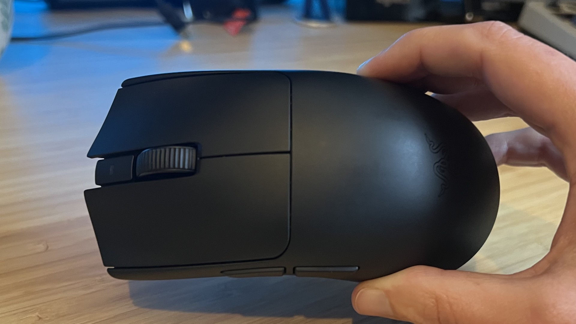 Razer Viper V4 Pro gaming mouse being held on its side