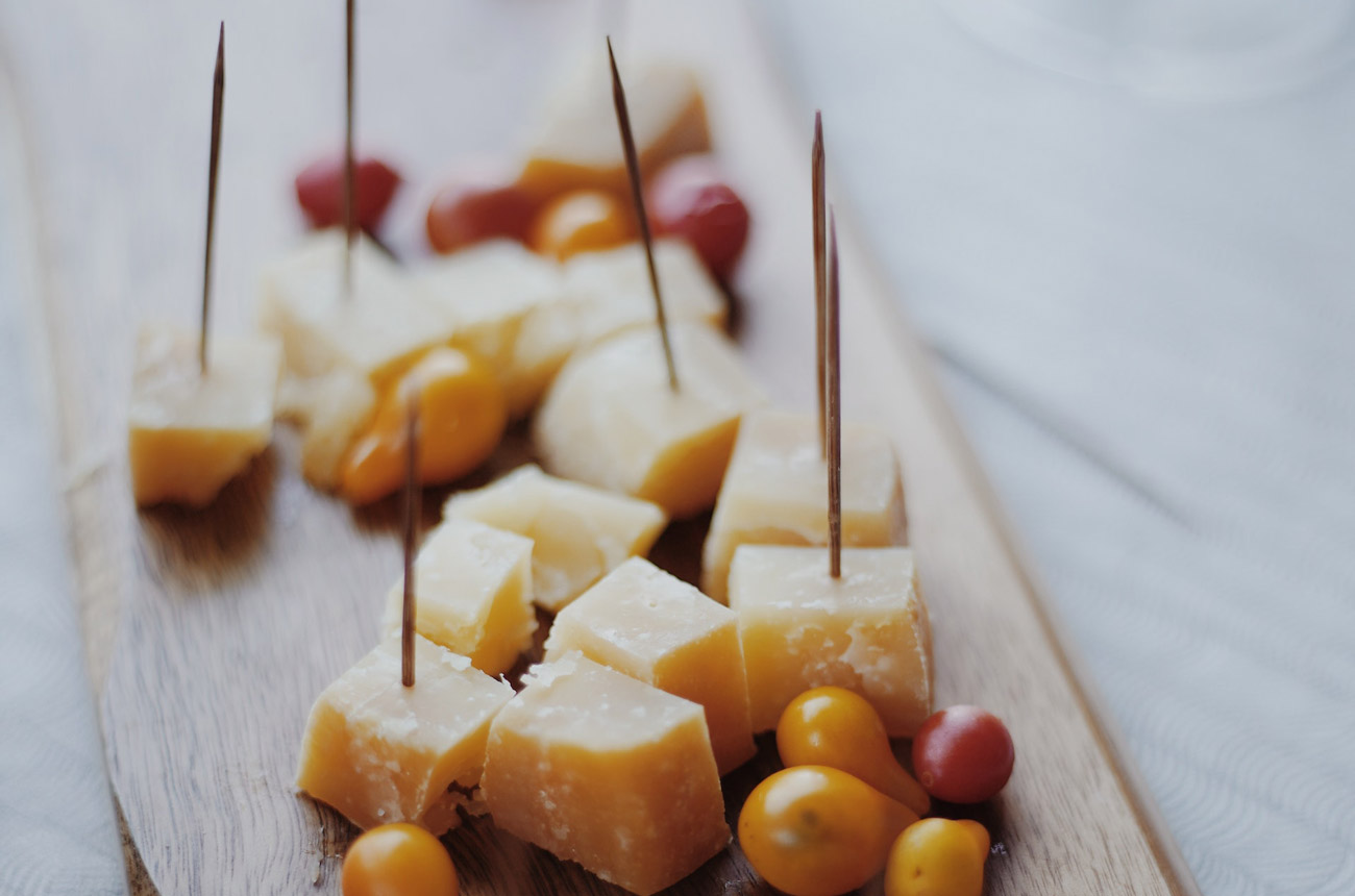 Chunks of cheese and olives on a board