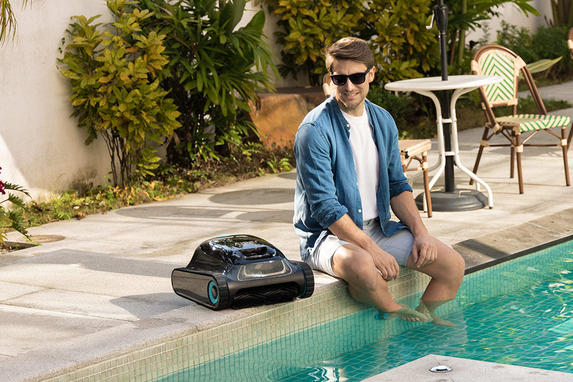 man sat next to pool with aiper device