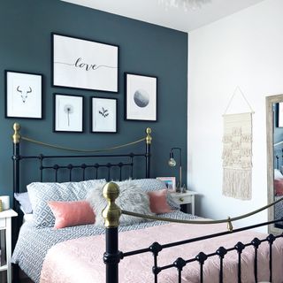 Bedroom with wrought iron bed and feature gallery wall