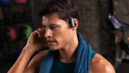 Anker Soundcore Spirit X2 review: Pictured here, a handsome man with a towel around his neck listening to the Soundcore Spirit X2
