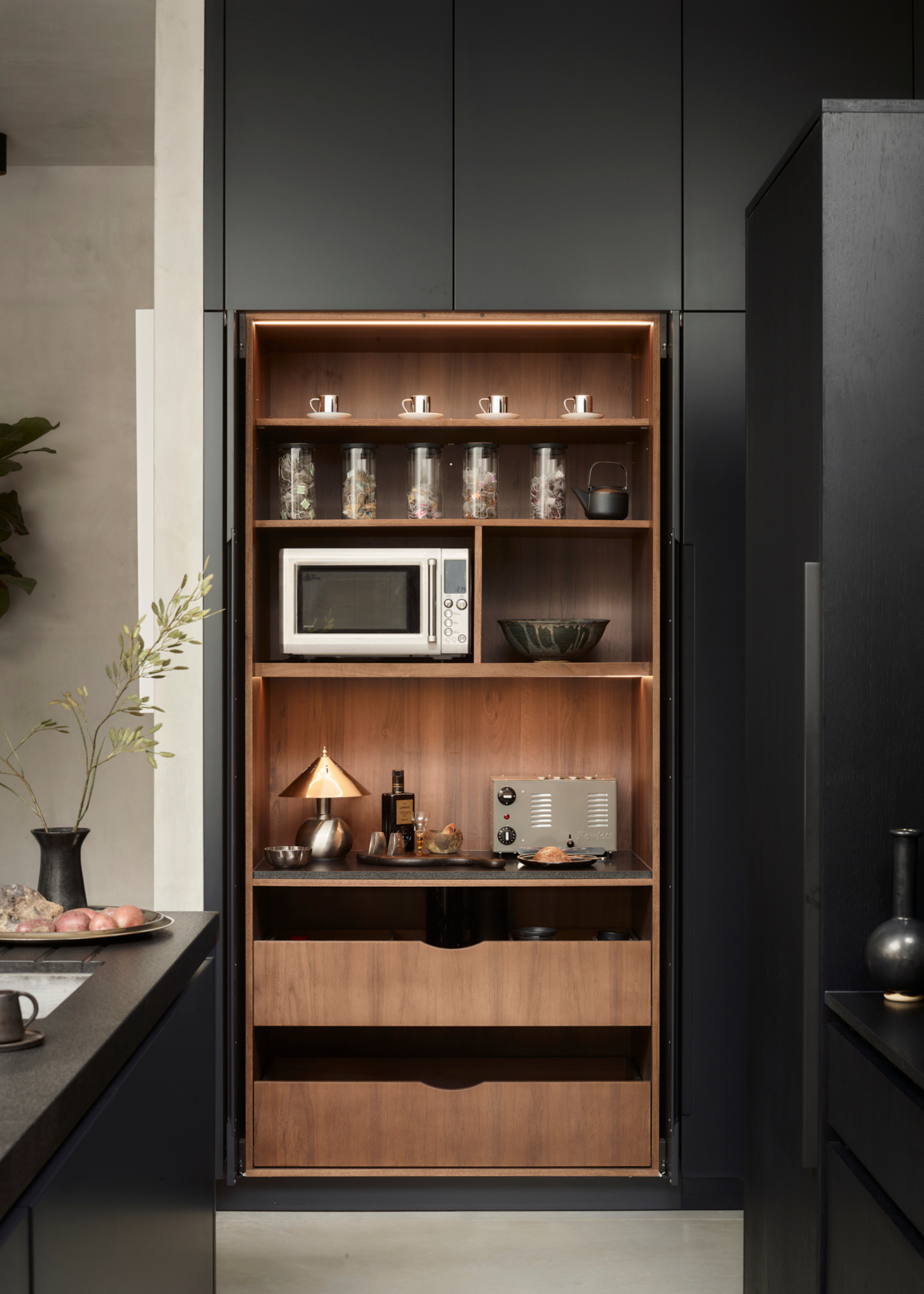 all black cabinets with a pocket door kitchen bar with oak interiors