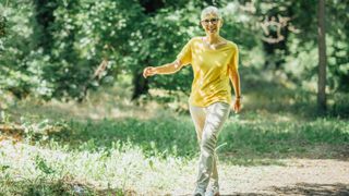 Woman looks energized as she walks in nature