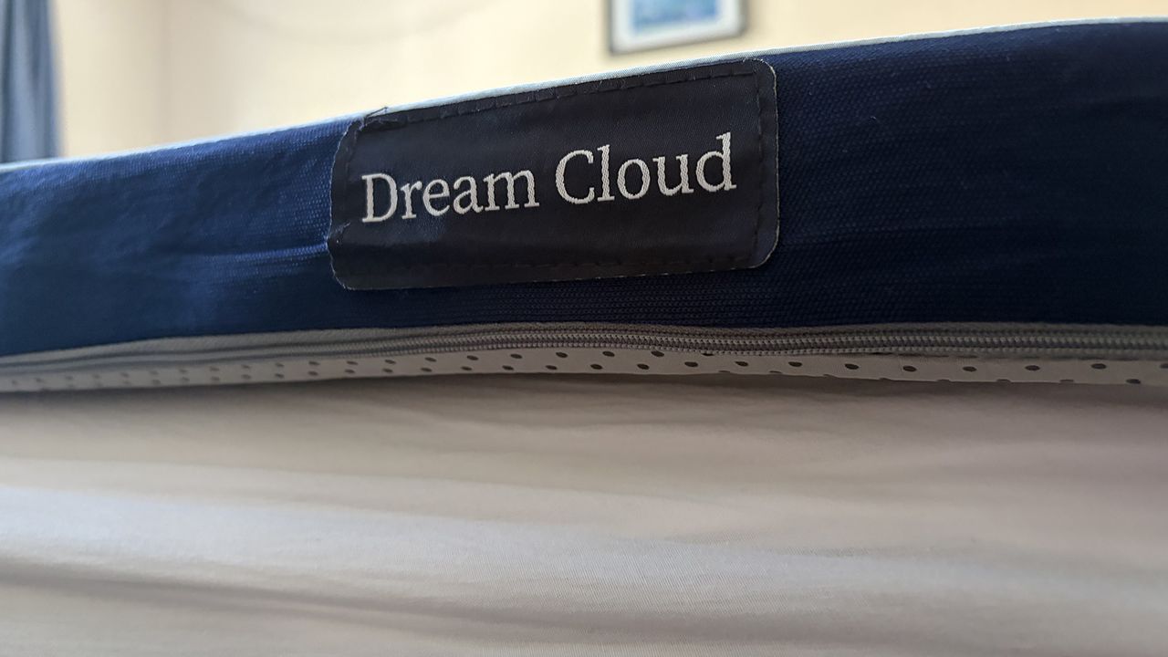 A close up of the corner of the DreamCloud Softer Mattress Topper on the bed in the bedroom of our reviewer Ruth Jones