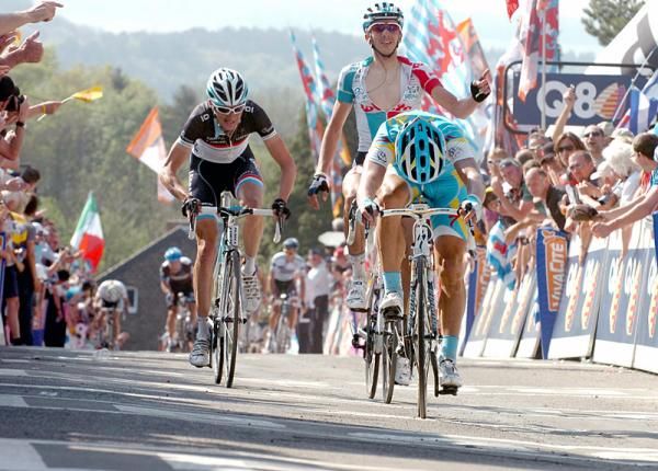Alexandre Vinokourov (Astana) powers to the line for a 4th place finish while Jelle Vanendert (Omega Pharma-Lotto) celebrates Gilbert's win.