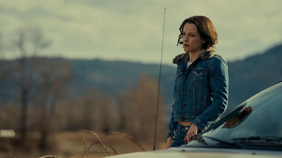 Riley Keough as Rebecca Godfrey, standing next to a car in &quot;Under the Bridge&quot;