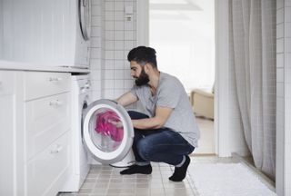 Man using a washing machine