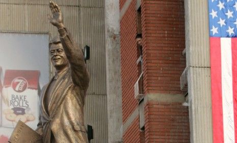 Former U.S. President Bill Clinton speaks in front of his statue in Pristina, Kosovo on November 1, 2009.