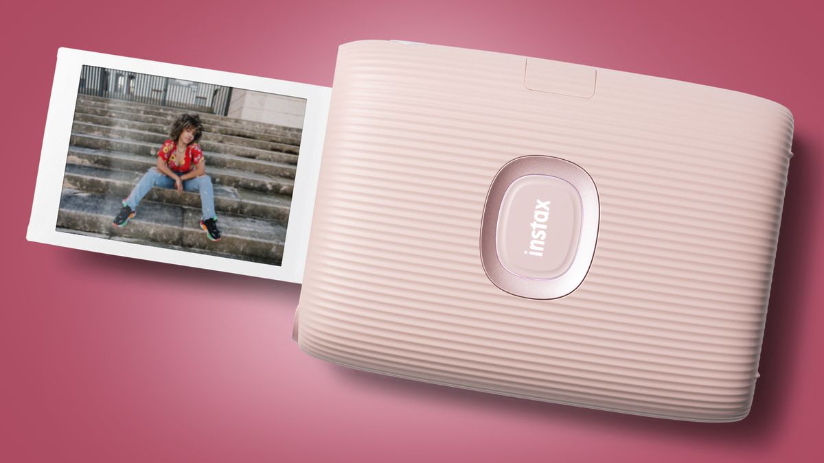 An Instax Mini printer printing out a photo