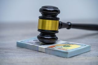 Judge's hammer gavel and bank note.Representation of corruption and bribery in the judiciary