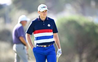 Jordan Spieth walks with a wedge in his hand