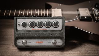 The Warm Audio WA-C1 pedal sits next to a guitar