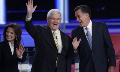 GOP presidential contenders Newt Gingrich and Mitt Romney share a laugh during a debate Monday in New Hampshire.
