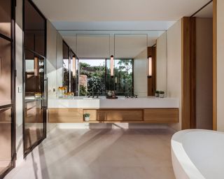 A bathroom with floating doule vanity and Critall door showers with cognac glass