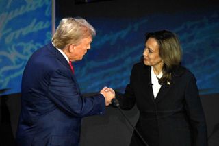 Donald Trump and Kamala Harris shaking hands on debate stage