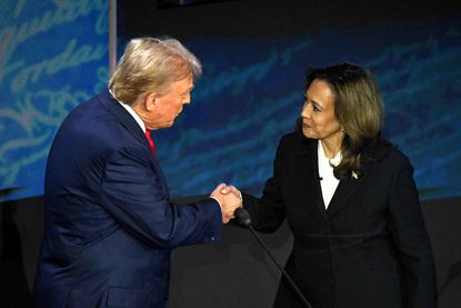 Donald Trump and Kamala Harris shaking hands on debate stage