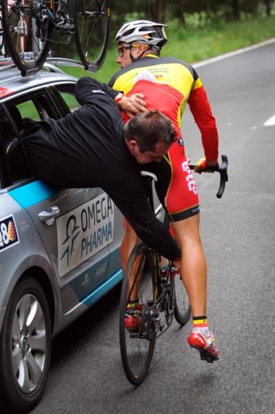 Philippe Gilbert (Omega Pharma-Lotto) gets some assistance from the team car.