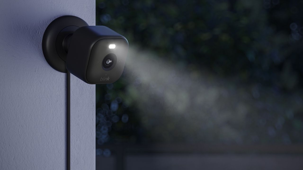 Blink Outdoor camera on wall at night with spotlight