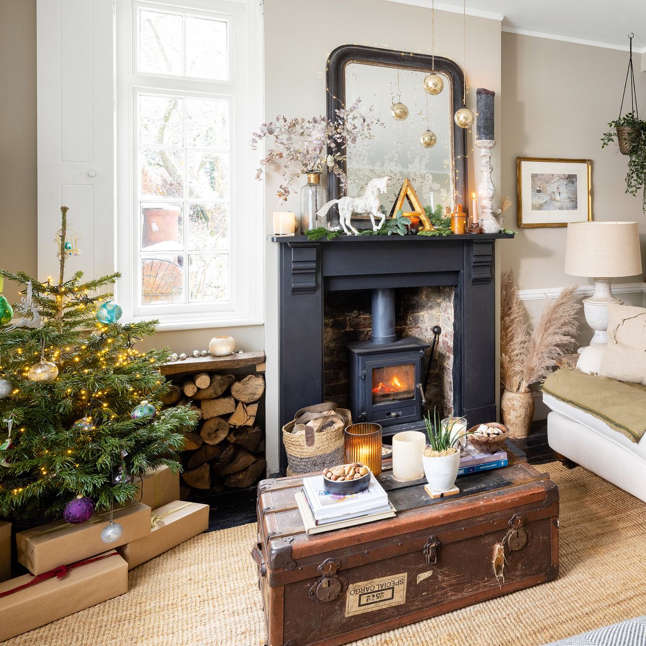 family living room with woodburner and fireplace with a small Christmas tree