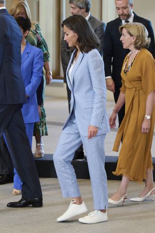 Queen Letizia of Spain in a blue linen suit with white sneakers at a board meeting with the Patronage of the Gallery of the Royal Collections in Madrid, Spain May 2024