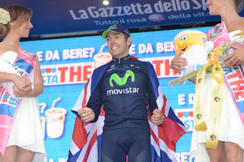 Alex Dowsett celebrates his stage win on the podium