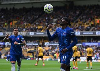 Noni Madueke of Chelsea celebrates with teammate Enzo Fernandez after scoring his team&#039;s fifth goal and completing his hat trick during the Premier League match between Wolverhampton Wanderers FC and Chelsea FC at Molineux on August 25, 2024 in Wolverhampton, England.