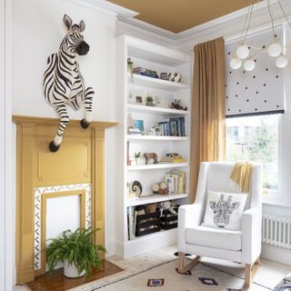 mustard and white nursery with zebra wall decoration
