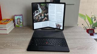 Lenovo ThinkPad X1 Fold 16 review unit on a desk showing a pdf