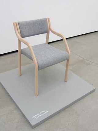 A wooden chair with grey cushioning