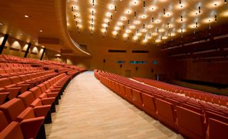 The main auditorium's red armchairs by Poltrona Frau were also designed by Studio Fuksas.