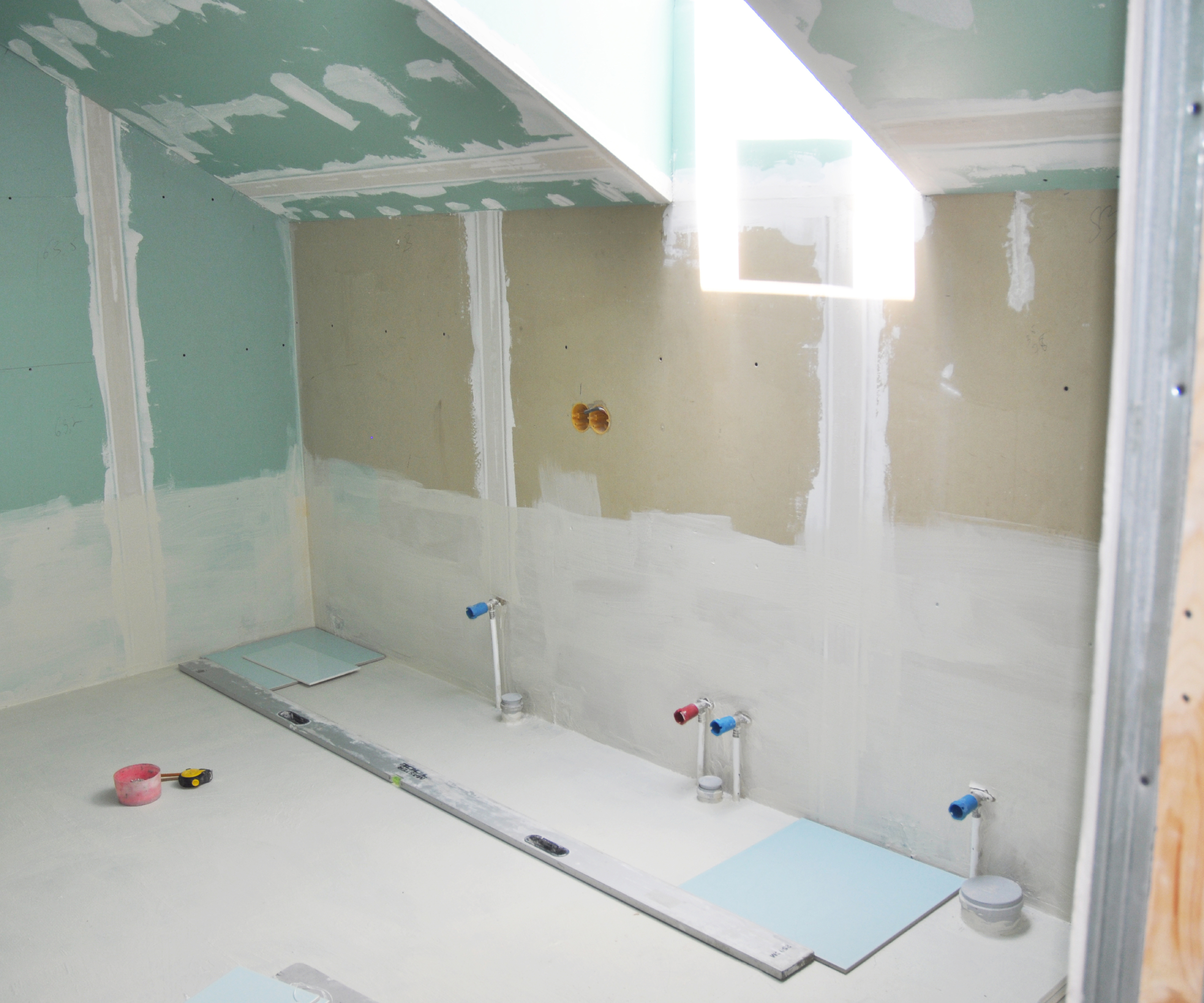 bathroom with plasterboard walls ready for painting