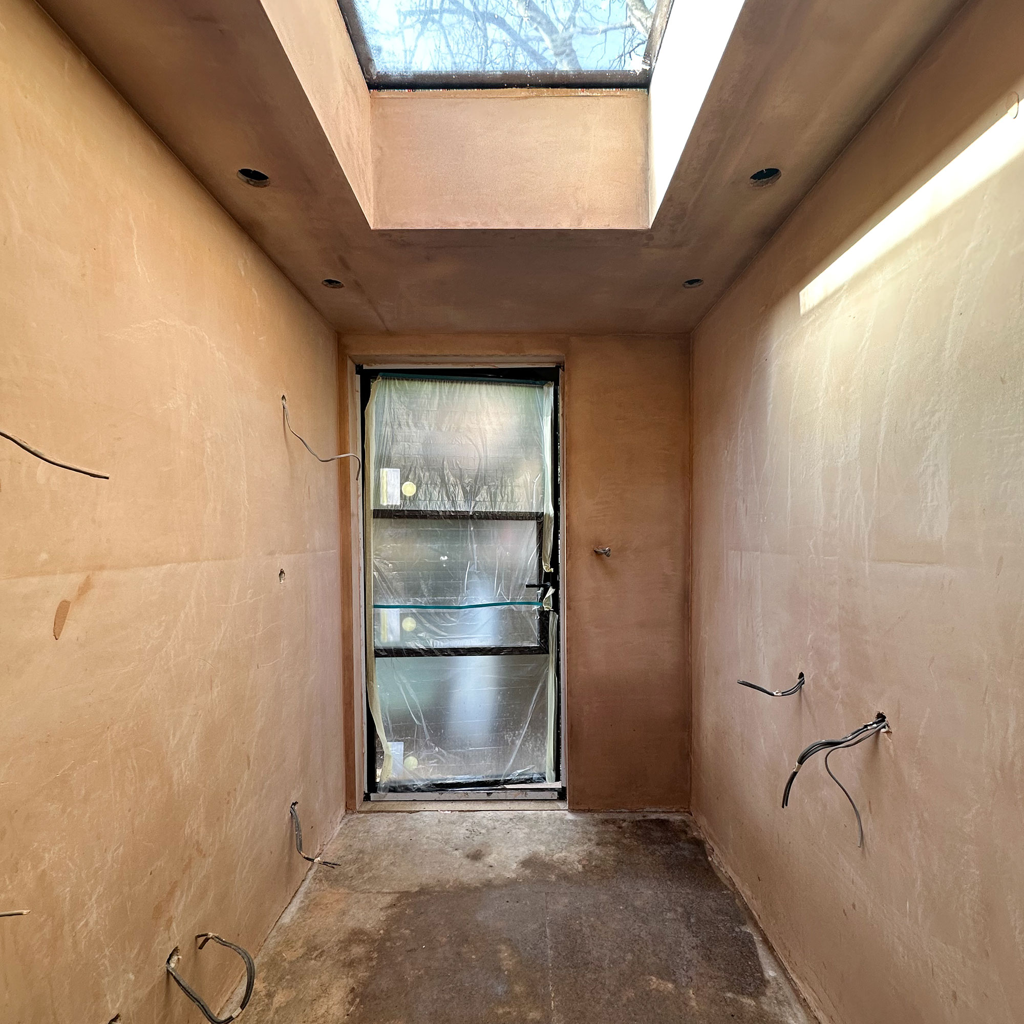 Interior of newly built space with bare surfaces and exposed wiring