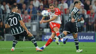 Harry Kane (C) strikes the ball ahead of the Man Utd vs Bayern Munich live stream